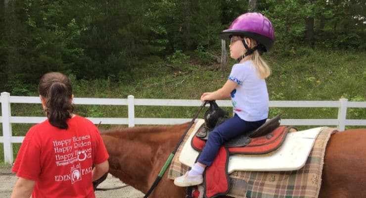 Child riding a horse at Eden Farms.