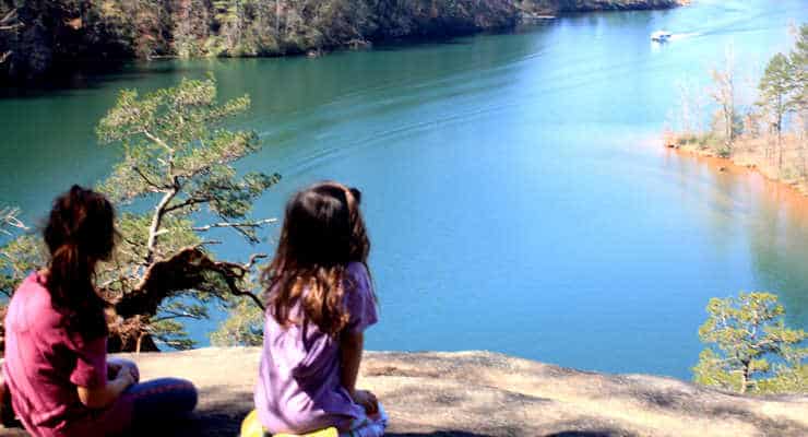 Two girls sitting on Raven Rock looking at Lake Keowee