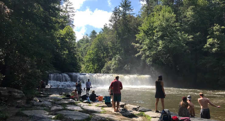 People on the shore enjoying view of Hooker Falls