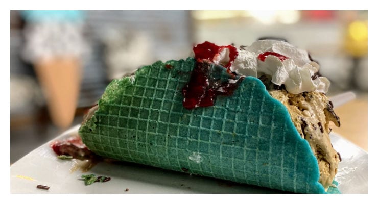 Ice cream dessert in a blue taco shaped waffle cone