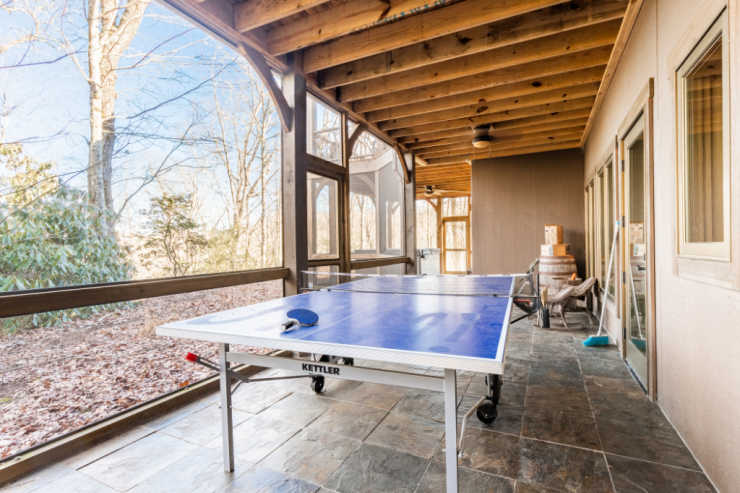 ping pong table on back porch in mountain rental home