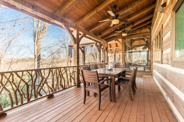 back porch with dining table and chairs in mountain rental home