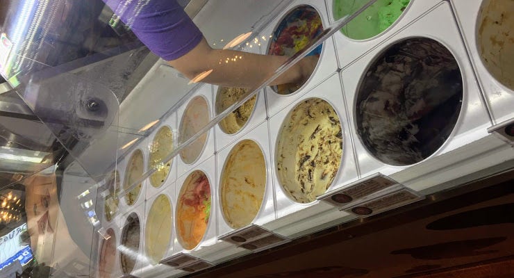 Worker scooping ice cream at Hub City Scoops