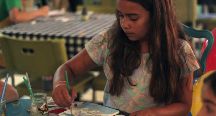 Child at The Art Cafe in Hilton Head painting pottery