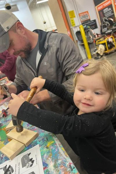 Working alongside Dad at Home Depot free kids workshop