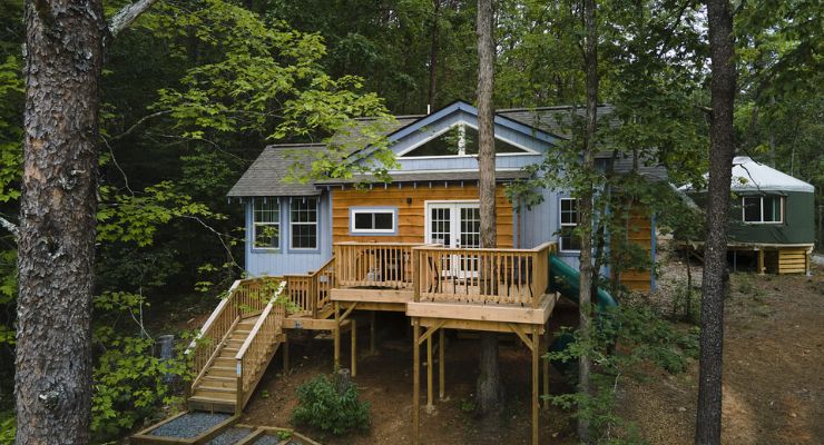 Treehouse with a slide that you can book at Emberglow Outdoor Resort