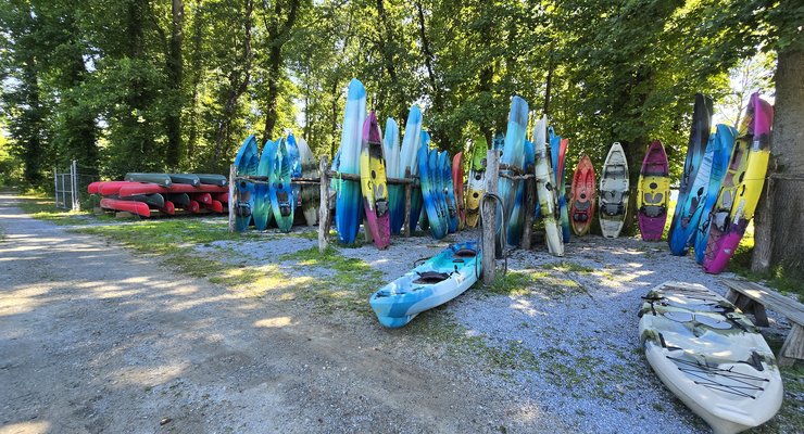 Colorful kayaks lined up at Headwaters Outfitters in Rosman NC
