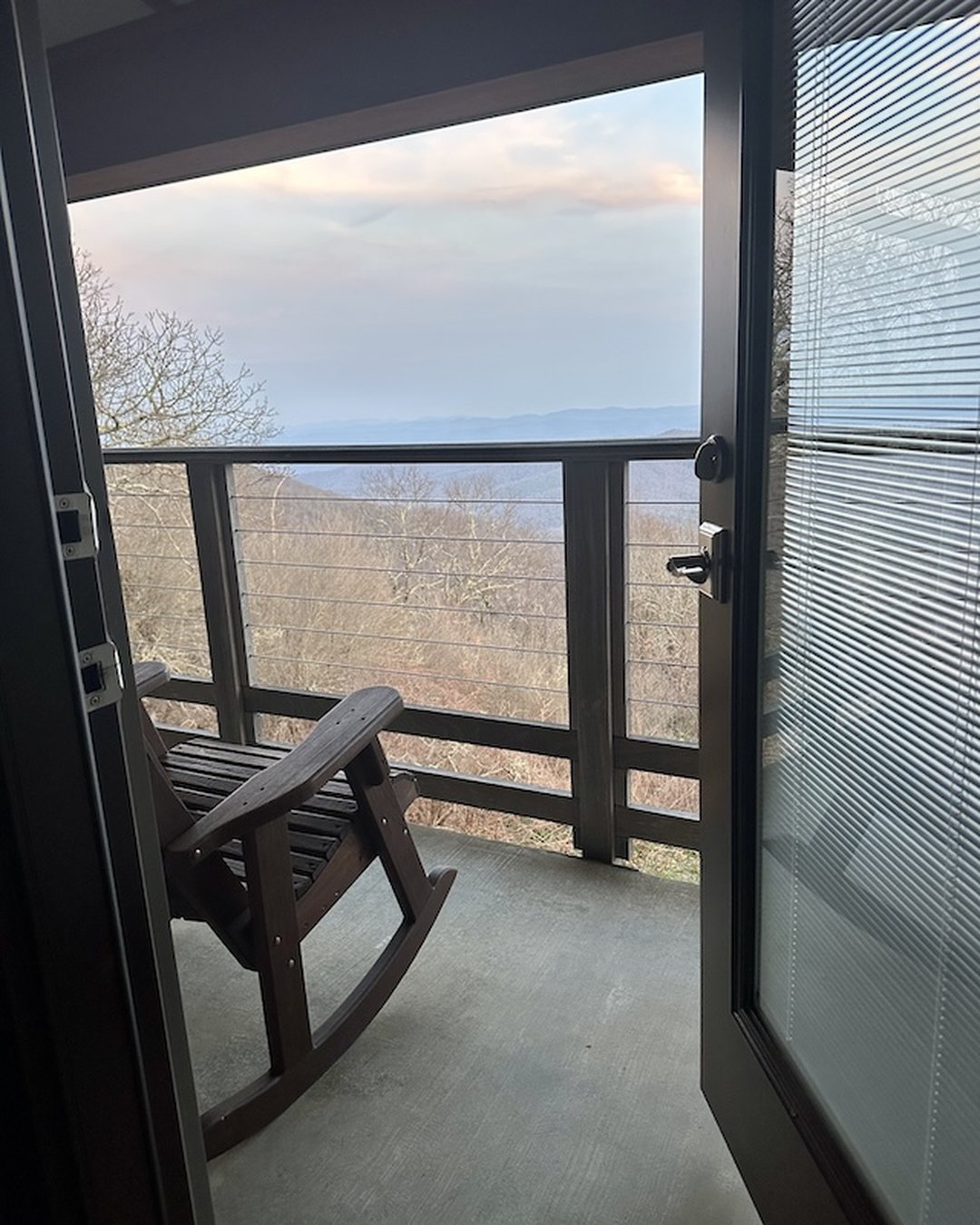 Rocking chairs on private balcony at Pisgah Inn with Blue Ridge mountain panorama
