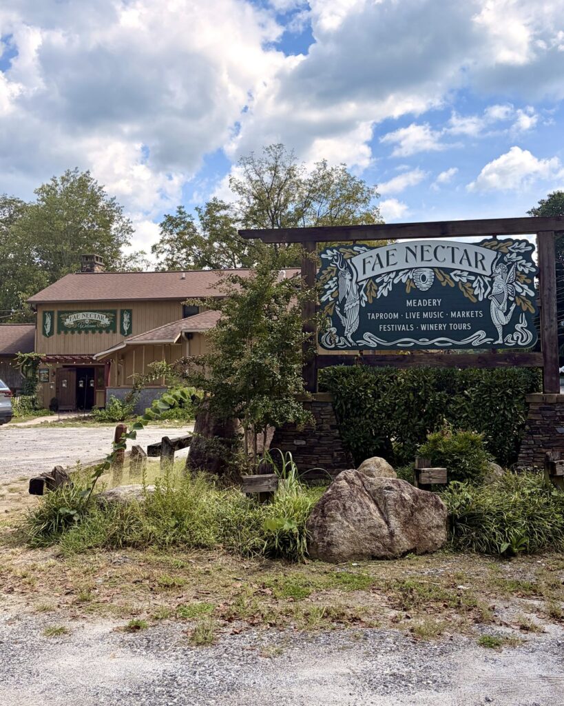 Fae Nectar meadery entrance sign listing meadery taproom live music markets festivals and winery tours in Lake Lure NC