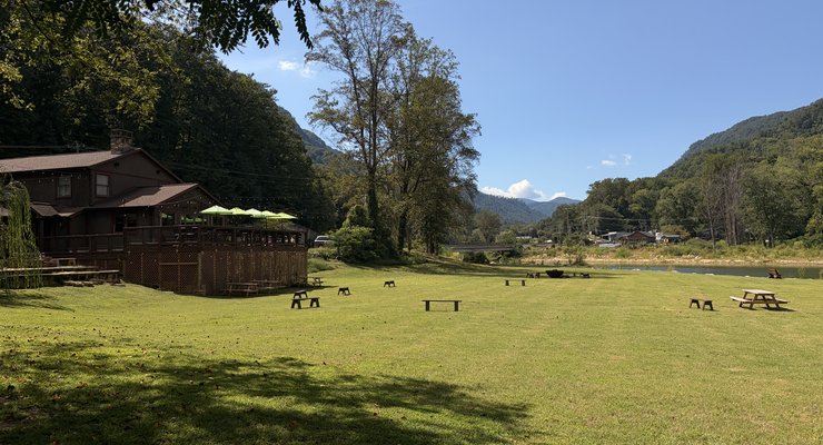 Fae Nectar festival lawn with outdoor seating deck and mountain views in Lake Lure NC