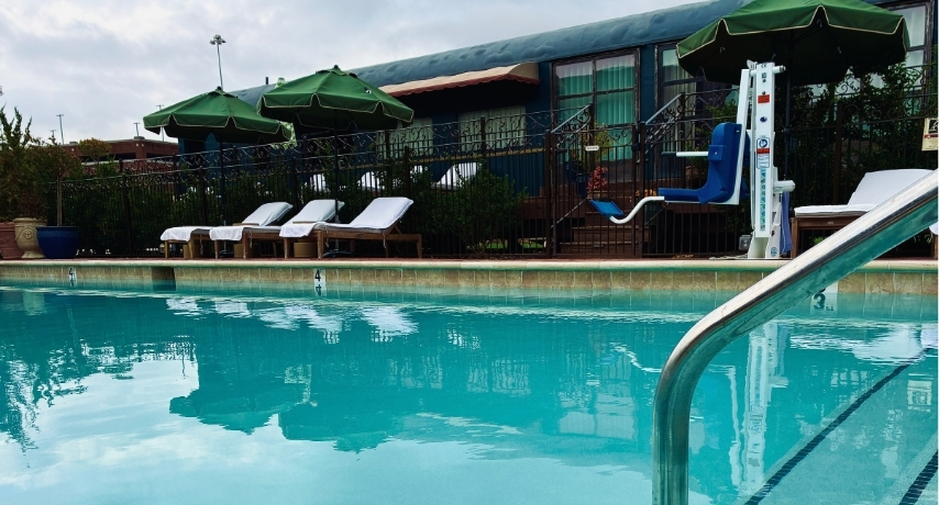 Stairs descending into a pool next to a train car