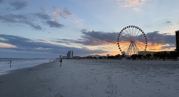 Ferris wheel on the Myrtle Beach skyline at sunset seen from the beach