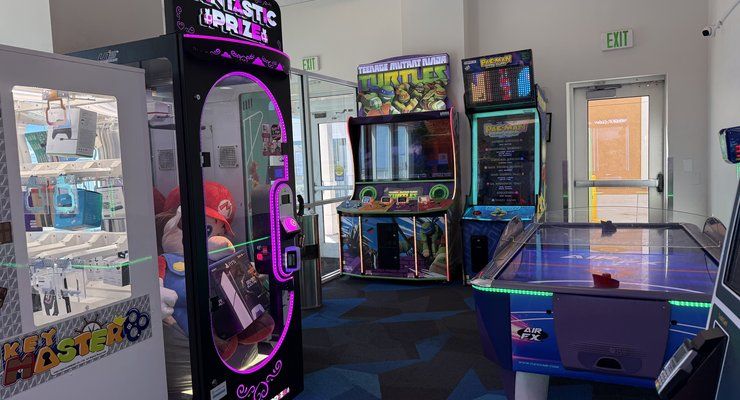 Small kids arcade with claw machine, arcade games, and an air hockey table at Westgate Myrtle Beach Oceanfront Resort