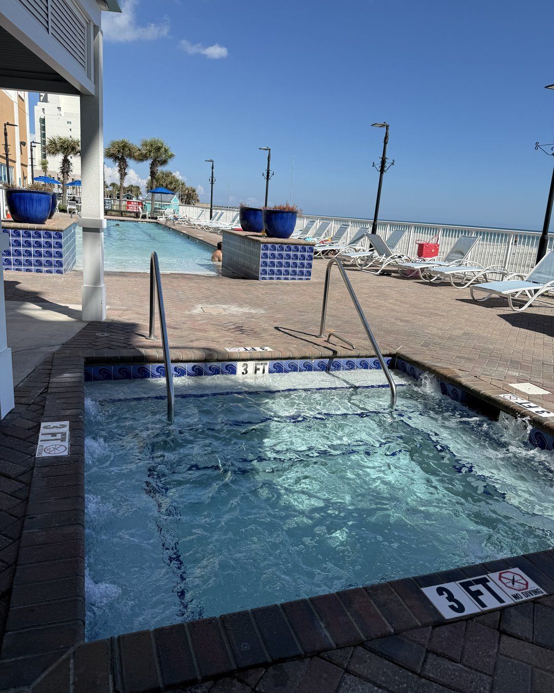 Hot tub beside the pool deck at Westgate Myrtle Beach Oceanfront Resort with the ocean in the background